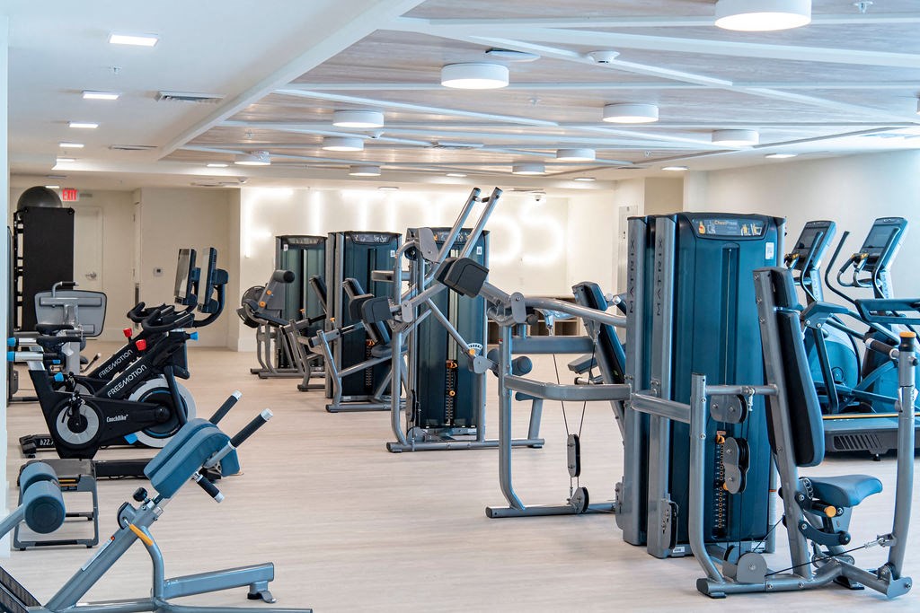 a room filled with lots of different types of exercise equipment