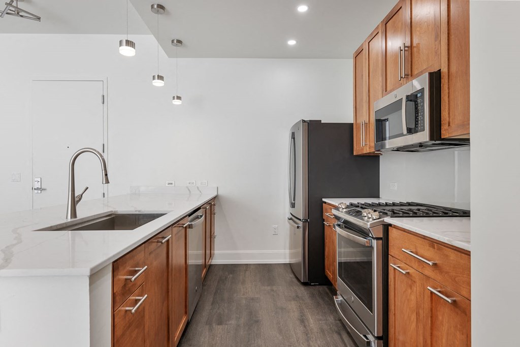 a kitchen with wooden cabinets and stainless steel appliances