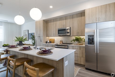 a kitchen with stainless steel appliances and a white counter top