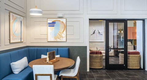 a dining room with blue booths and a wooden table and chairs