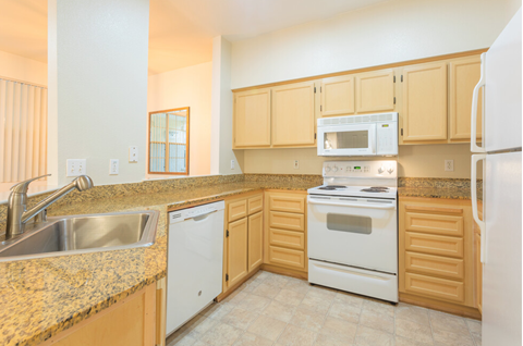 a kitchen with granite counter tops and white appliances