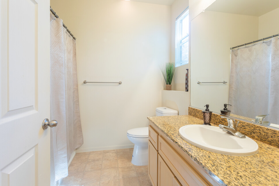 a bathroom with a sink and a toilet and a shower
