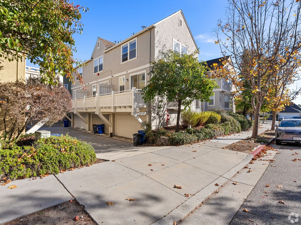 A residential area with a house, trees, and a car at Westmont Place Townhomes Apartments, Santa Cruz, California