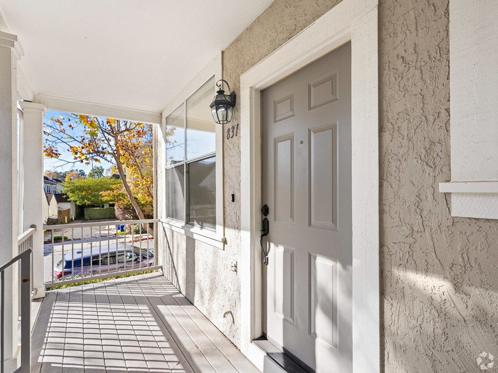 A white door is on the right side of a hallway at Westmont Place Townhomes Apartments, Santa Cruz