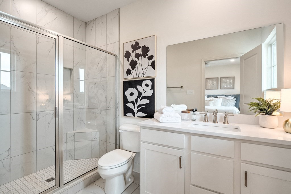 a bathroom with a shower and a sink and a toilet