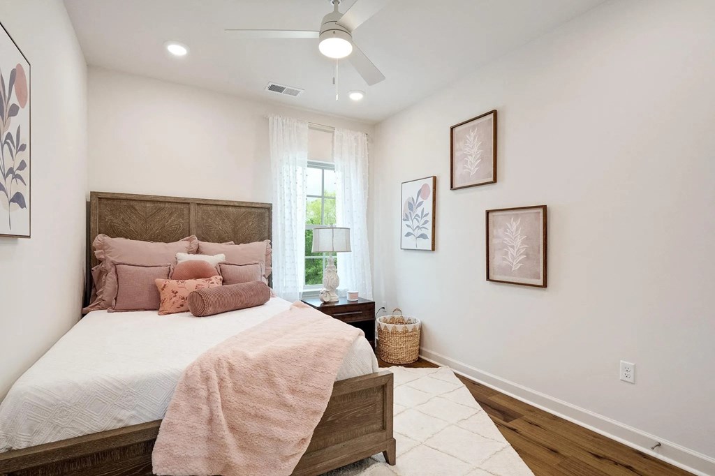 a bedroom with a bed and a ceiling fan