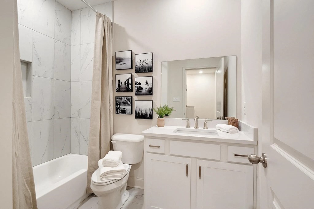 a bathroom with a sink and a toilet and a shower
