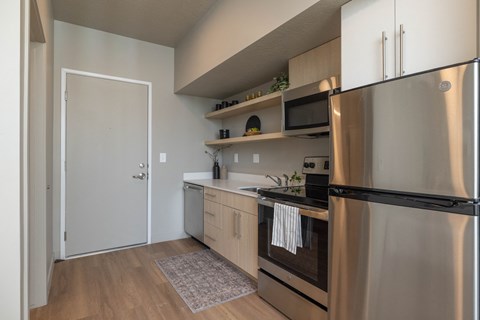 a kitchen with stainless steel appliances and a stainless steel refrigerator