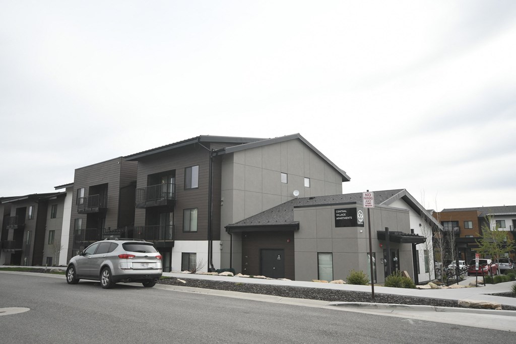 a silver car parked in front of a building