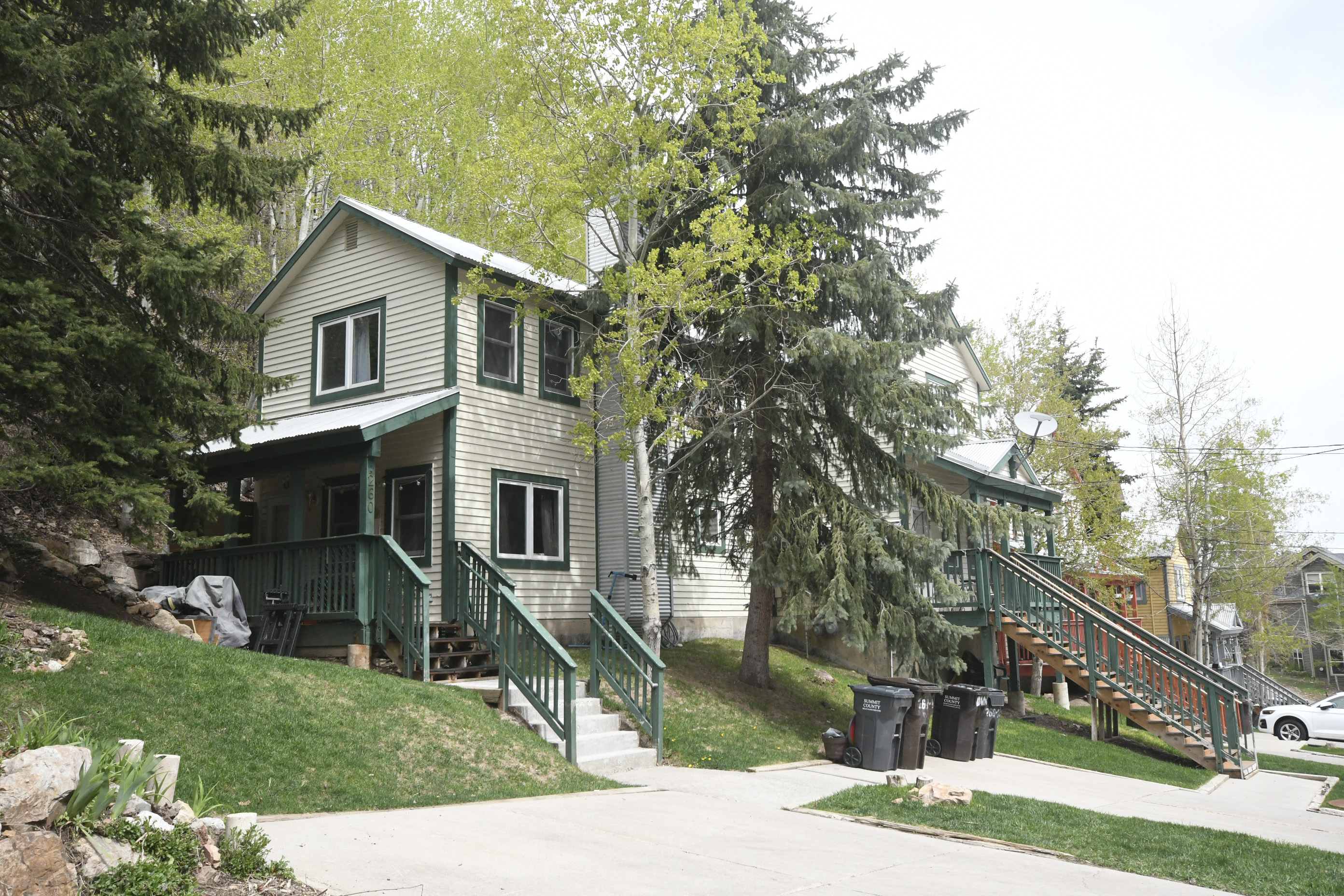 a house on the side of a hill with trees