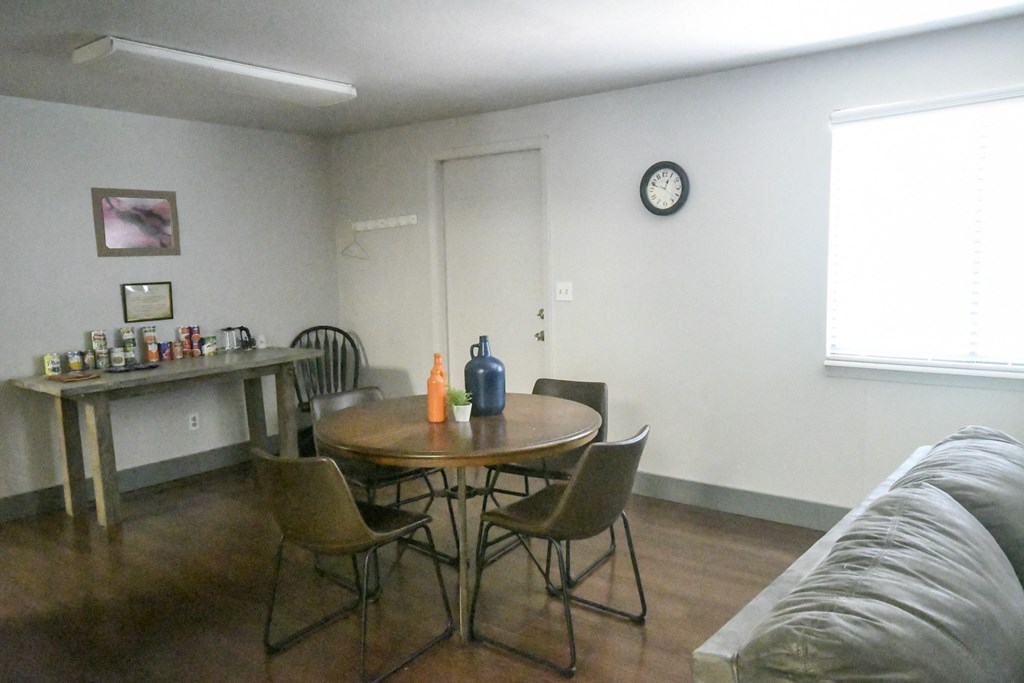 a living room with a table and chairs and a couch