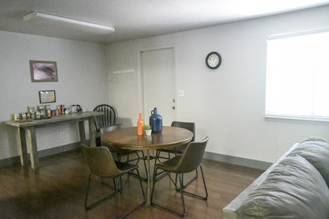 a living room with a table and chairs and a couch