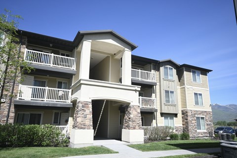 an apartment building with stone pillars and balconies