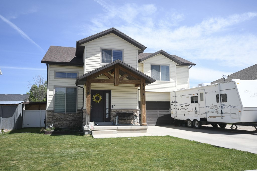 a house with an rv parked in front of it