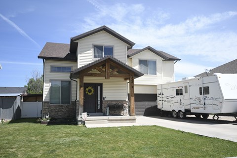 a house with an rv parked in front of it