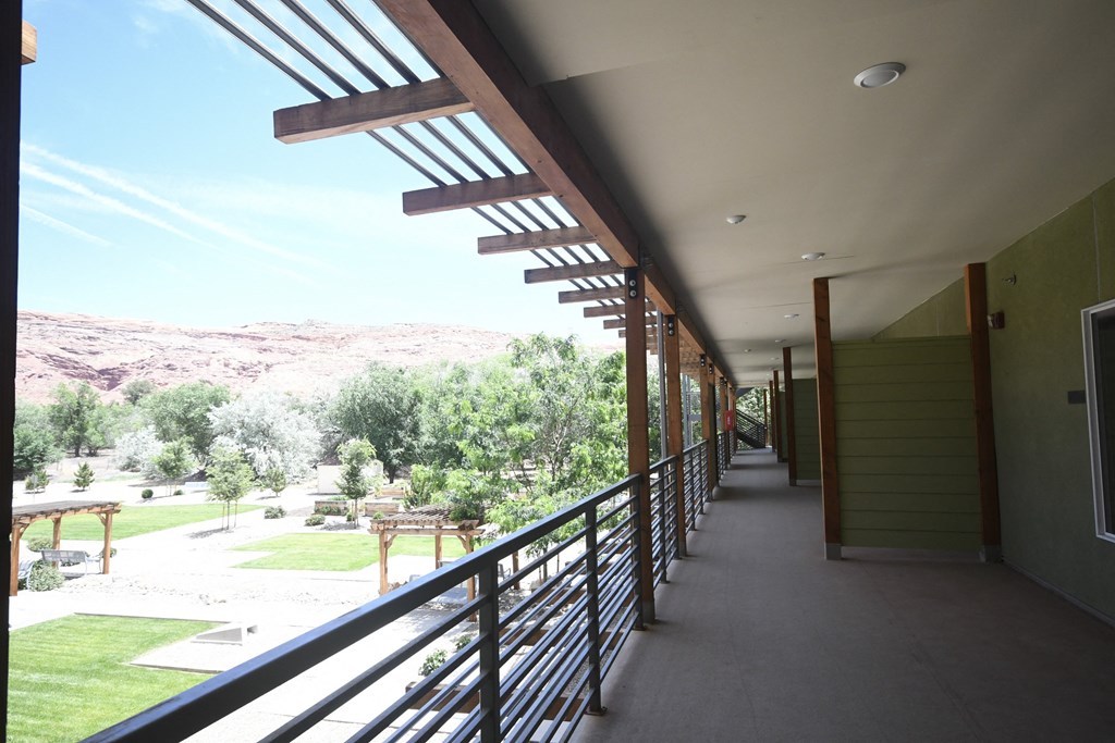 a long balcony with a view of the mountains