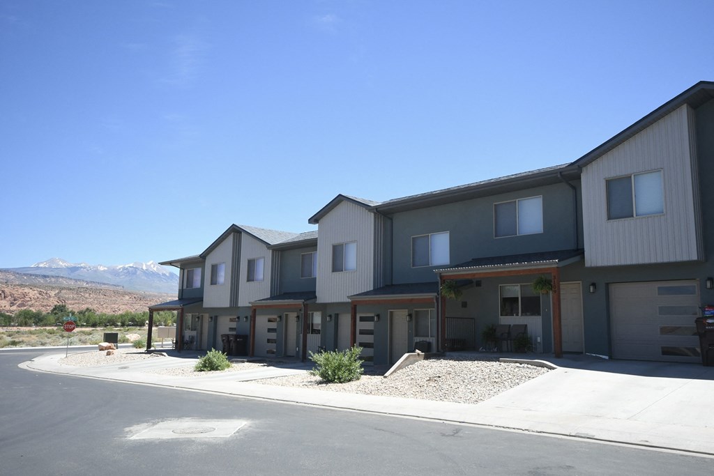 a row of houses with mountains in the background