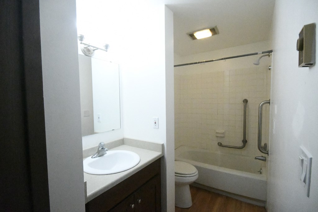 an empty bathroom with a sink and a shower and a toilet