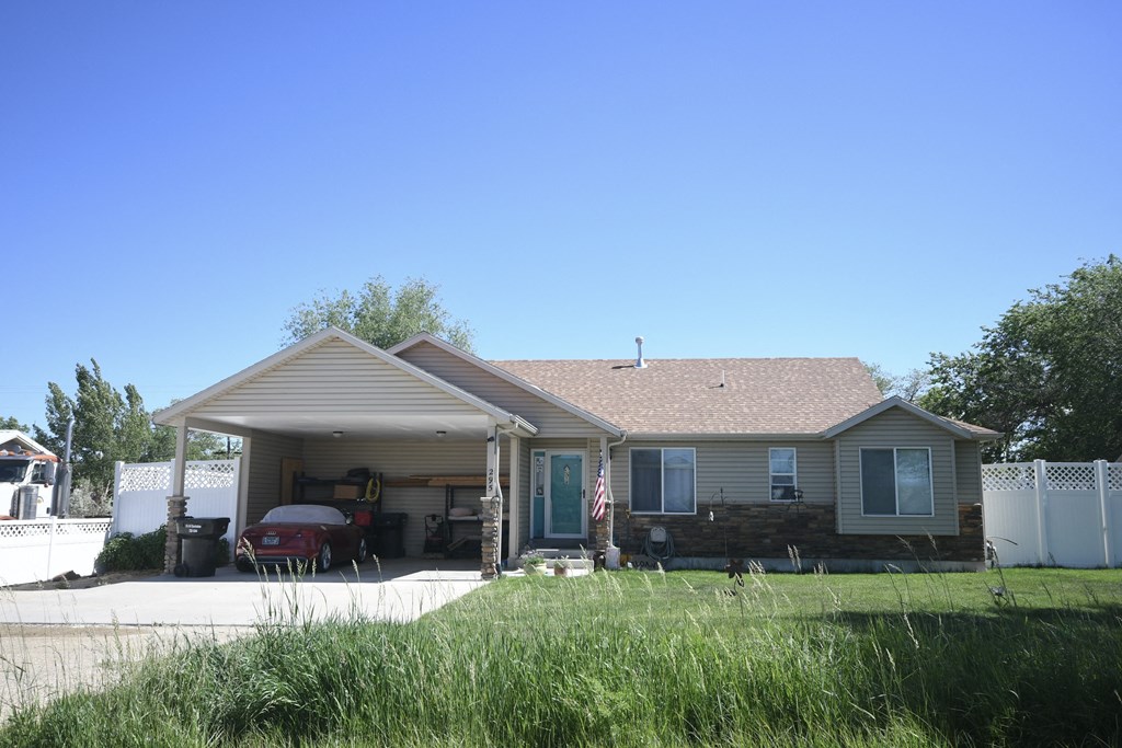 the front of a house with a car in the driveway