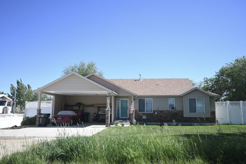 the front of a house with a car in the driveway