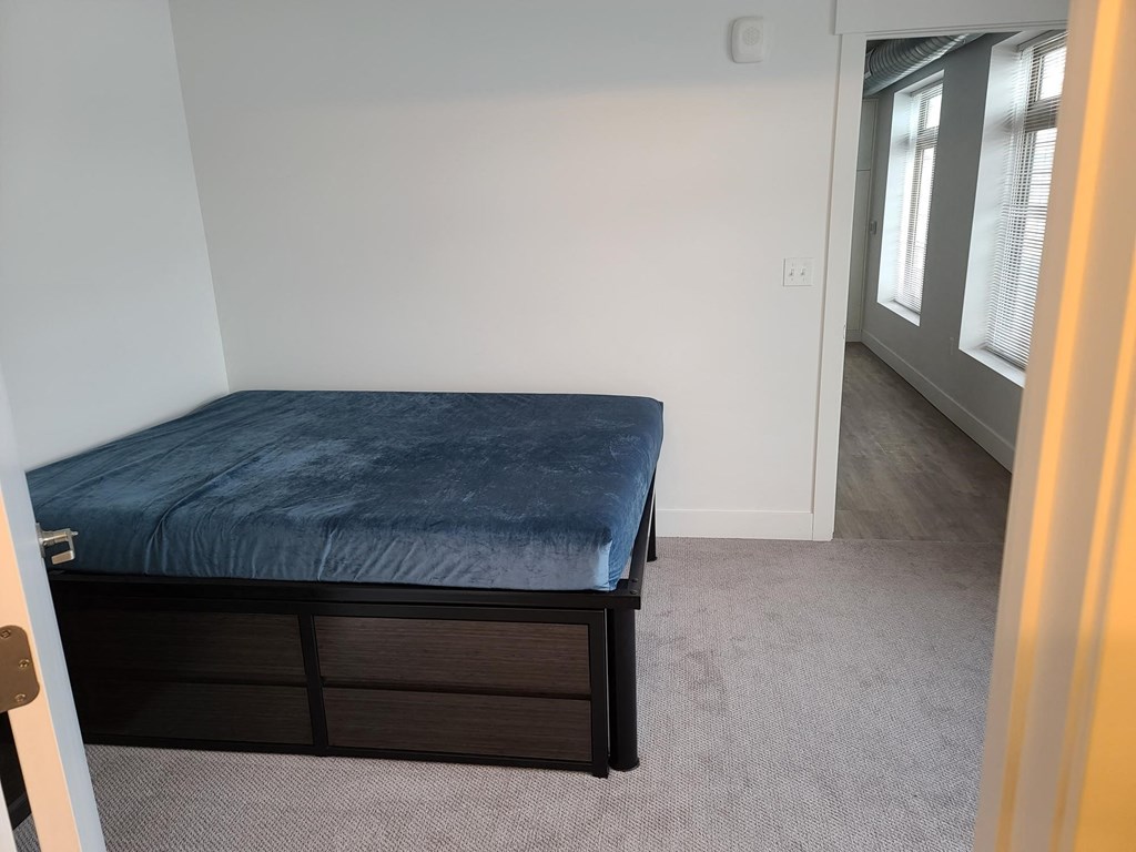 a bedroom with a bed and a window