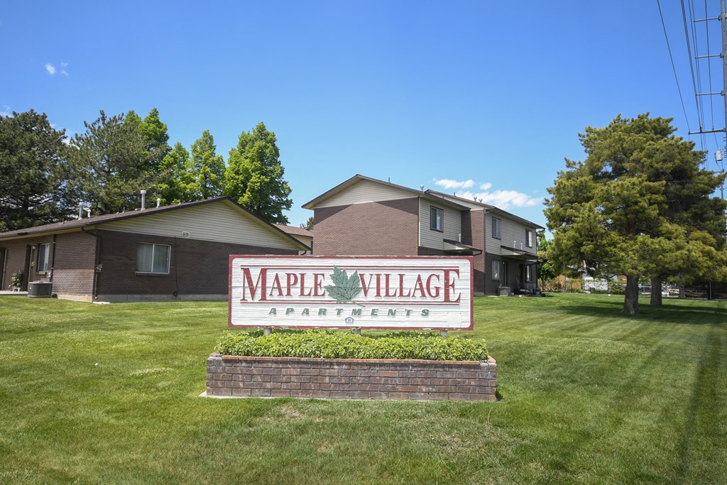 the sign in front of the maple village apartments
