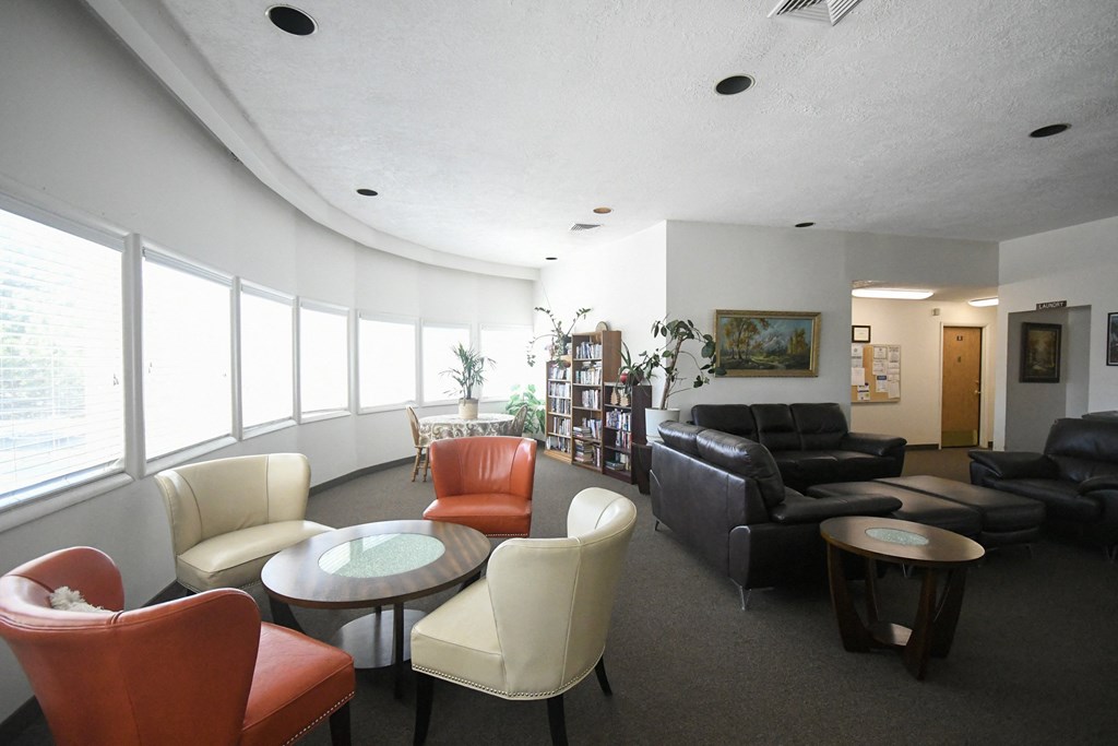 a living room with couches and chairs and a table