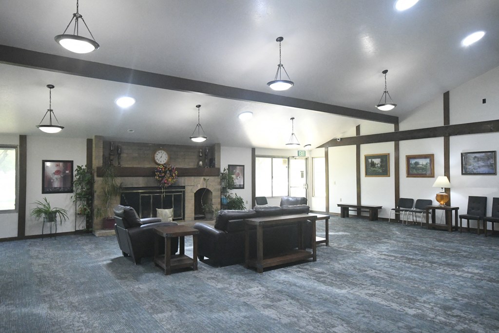 a large living room with couches and a fireplace