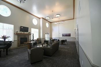 a large living room with couches and chairs and a fireplace