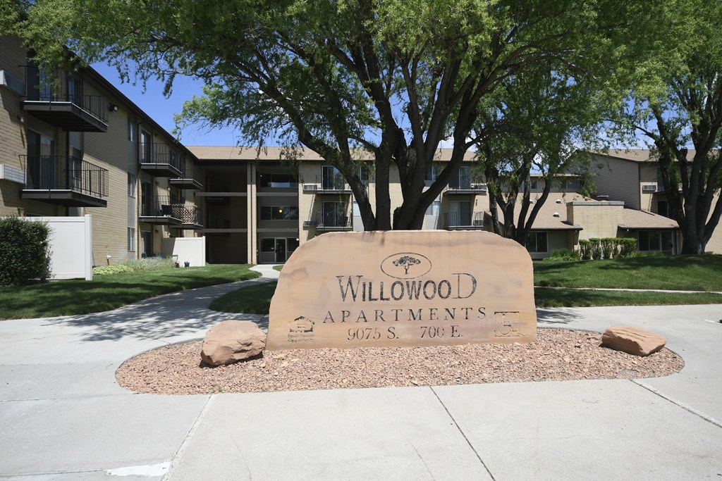 an apartment building with a sign that says willow apartments