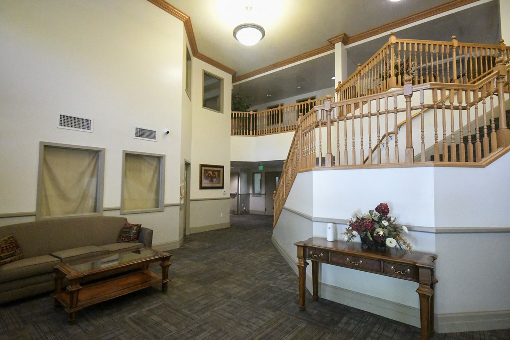 a living room with a staircase and a couch