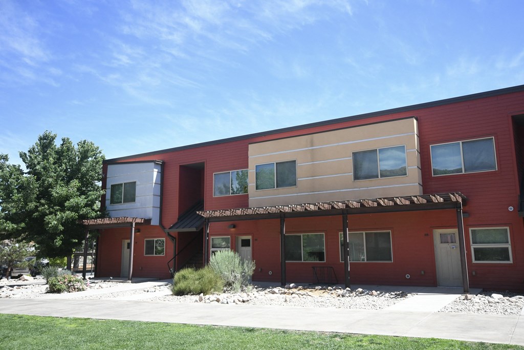 a red building with a blue sky in the background