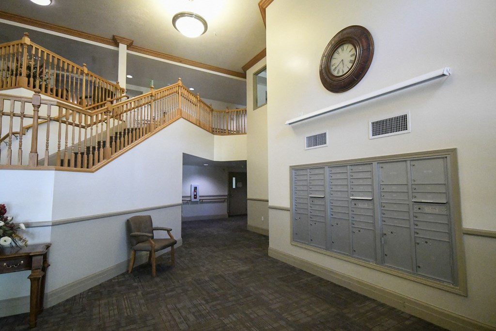 the lobby of a building with lockers and a clock
