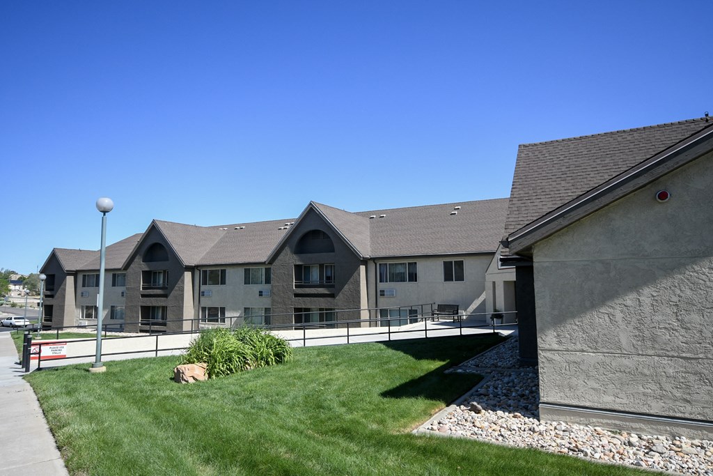 a view of a building with a grassy yard in front of it