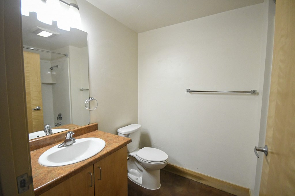 a small bathroom with a sink toilet and mirror