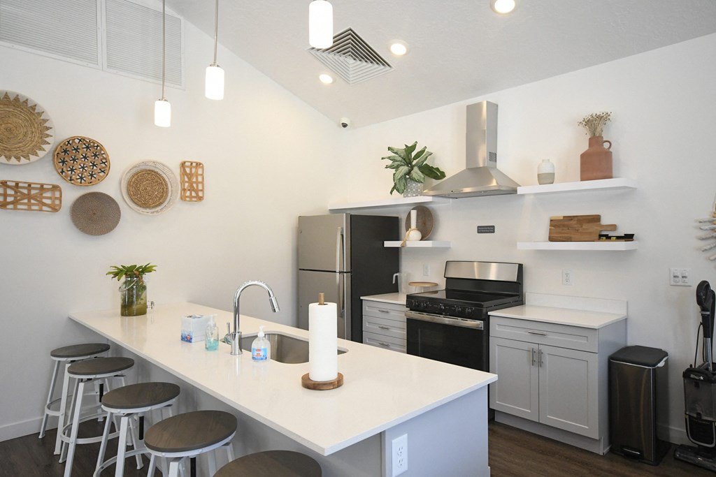 a kitchen with a large island and a counter top with stools