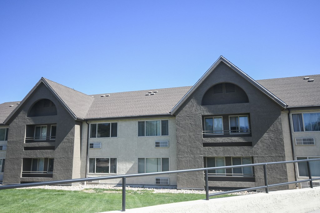 an apartment building with a fence in front of it