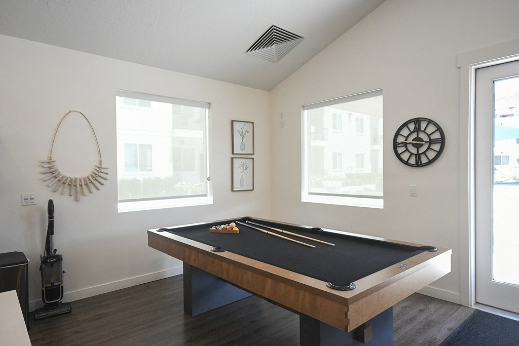 a games room with a pool table and a dart board