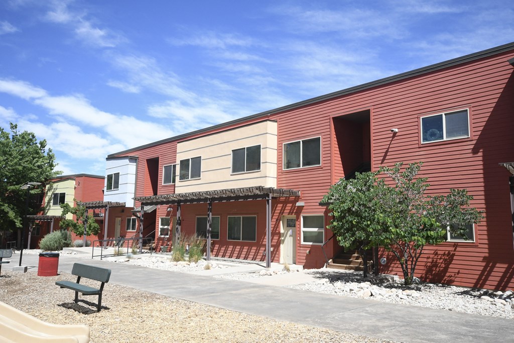 a red building with a bench in front of it