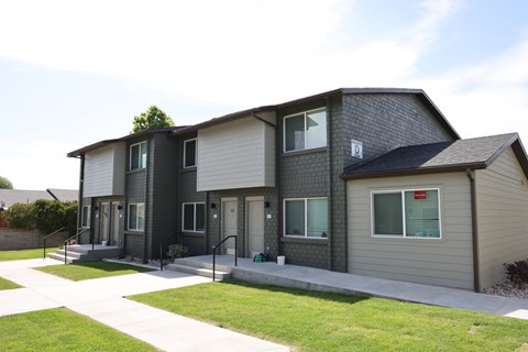 A modern two-story house with a grey and white exterior.