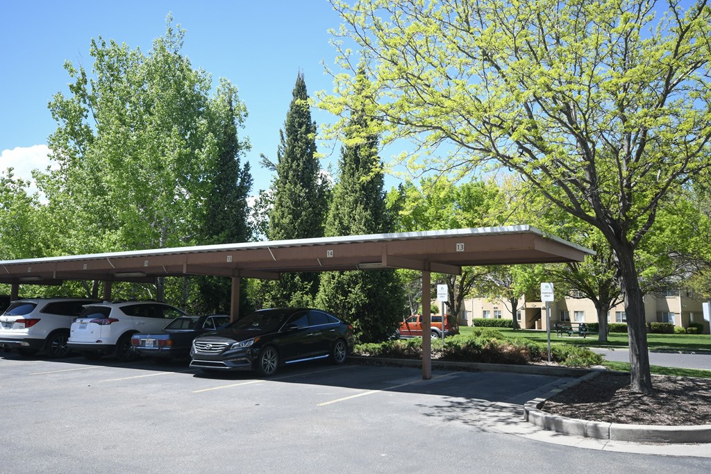 a parking lot with cars parked under a roof