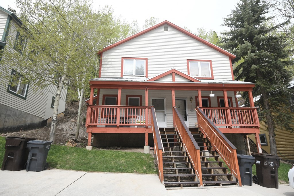 the front of the house with the new porch and stairs