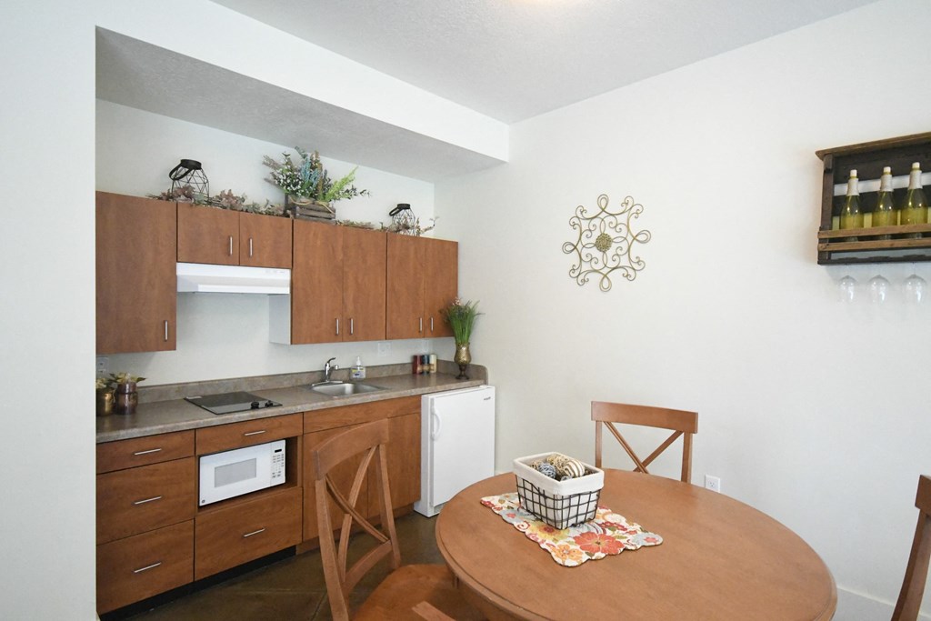 a small kitchen and dining area with a table and chairs