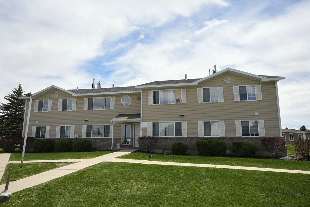 a large house with a sidewalk in front of it