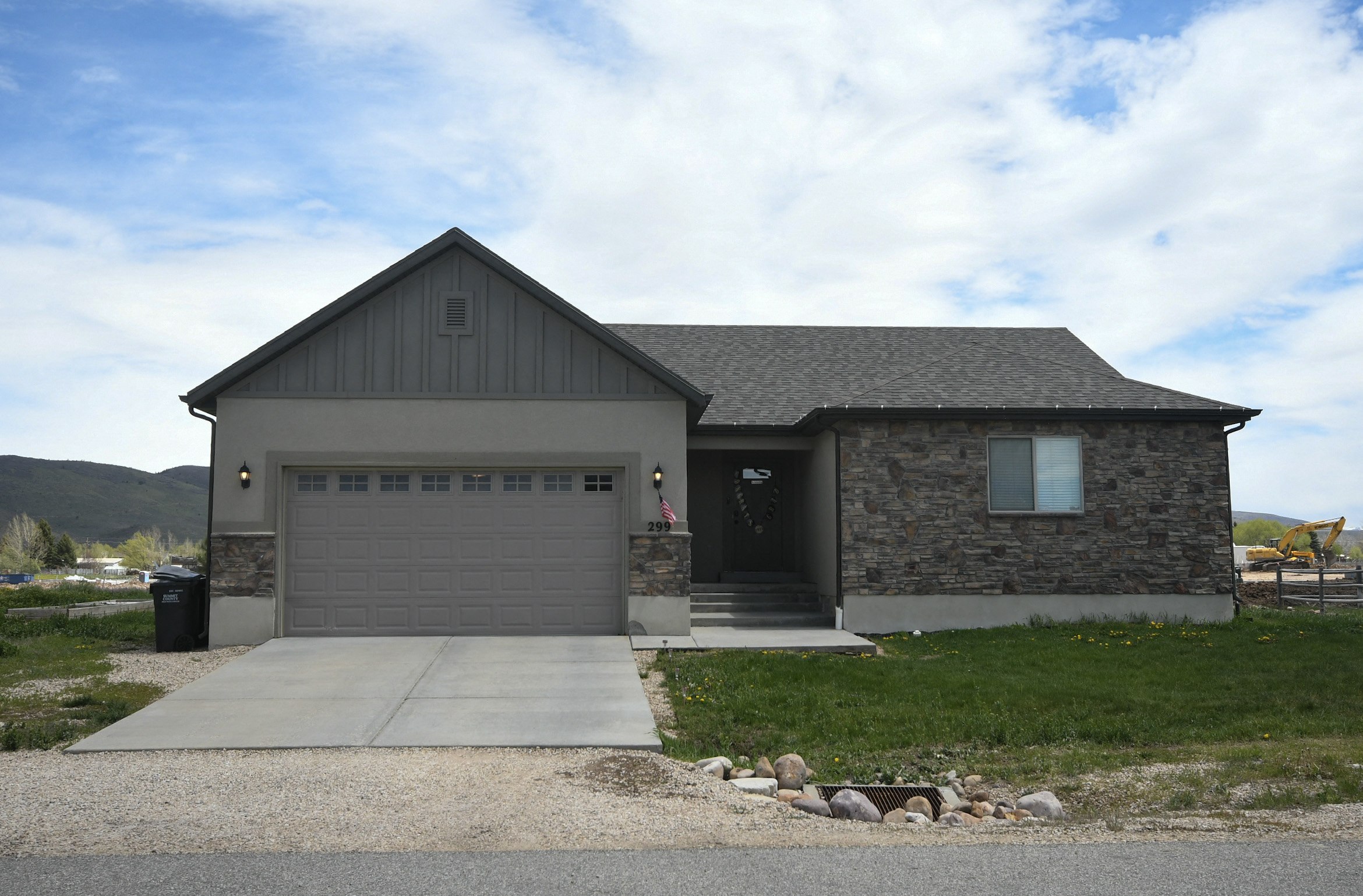the front of a house with a driveway and a garage door
