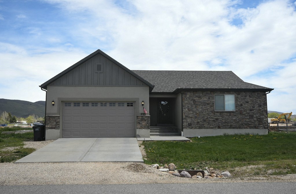 the front of a house with a driveway and a garage door