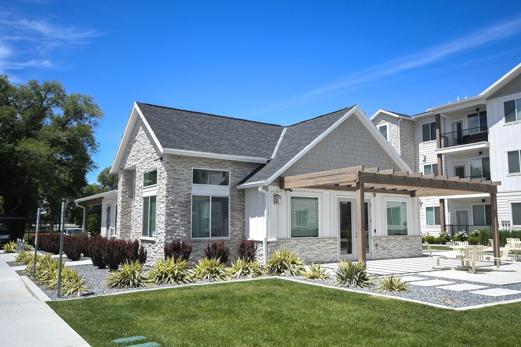 a house with a porch and a lawn in front of it