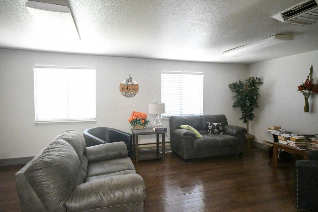an empty living room with couches and a table
