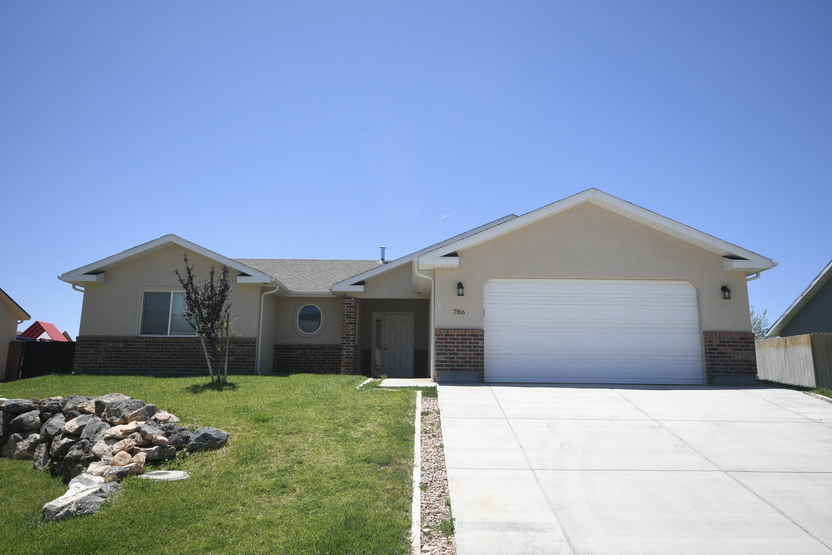 a house with a white garage door and a lawn