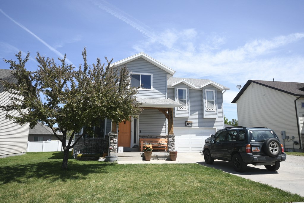 a car parked in a driveway in front of a house